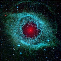 This infrared image from NASA's Spitzer Space Telescope shows the Helix nebula, a cosmic starlet often photographed by amateur astronomers for its vivid colors and eerie resemblance to a giant eye.<br /><br />The nebula, located about 700 light-years away in the constellation Aquarius, belongs to a class of objects called planetary nebulae. Discovered in the 18th century, these colorful beauties were named for their resemblance to gas-giant planets like Jupiter.<br /><br />Planetary nebulae are the remains of stars that once looked a lot like our sun. When sun-like stars die, they puff out their outer gaseous layers. These layers are heated by the hot core of the dead star, called a white dwarf, and shine with infrared and visible colors. Our own sun will blossom into a planetary nebula when it dies in about five billion years.<br /><br />In Spitzer's infrared view of the Helix nebula, the eye looks more like that of a green monster's. Infrared light from the outer gaseous layers is represented in blues and greens. The white dwarf is visible as a tiny white dot in the center of the picture. The red color in the middle of the eye denotes the final layers of gas blown out when the star died.<br /><br />The brighter red circle in the very center is the glow of a dusty disk circling the white dwarf (the disk itself is too small to be resolved). This dust, discovered by Spitzer's infrared heat-seeking vision, was most likely kicked up by comets that survived the death of their star. Before the star died, its comets and possibly planets would have orbited the star in an orderly fashion. But when the star blew off its outer layers, the icy bodies and outer planets would have been tossed about and into each other, resulting in an ongoing cosmic dust storm. Any inner planets in the system would have burned up or been swallowed as their dying star expanded.<br /><br />So far, the Helix nebula is one of only a few dead-star systems in which evidence for comet survivors has been found.<br /><br />This image is made up of data from Spitzer's infrared array camera and multiband imaging photometer. Blue shows infrared light of 3.6 to 4.5 microns; green shows infrared light of 5.8 to 8 microns; and red shows infrared light of 24 microns.<br /><br />Image Credit:  NASA/JPL-Caltech/Univ.of Ariz.