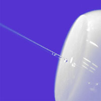NIST researchers and collaborators have developed a new method for measuring the interior dimensions of small holes with an uncertainty of only 35 nanometers. Here, a glass probe is inserted into an optical ’ferrule,’ a device for connecting optical fibers used in communications systems. <BR><BR>NIST Photo