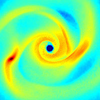 <p>
	View down onto the accretion disk that surrounds the newly born central star. Clearly visible are spiral arms of enhanced gas density which fragment to build up secondary stars. Blue colors indicate low density, red colors show regions of high density. The scale bar indicates a length of 30 Astronomical Units, where 1 Astronomical Unit corresponds to the distance between the Earth and the Sun.</p>
