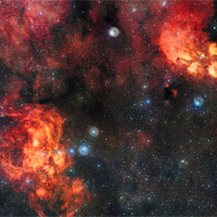 <p>This spectacular image from the VLT Survey Telescope shows the Cat’s Paw Nebula (NGC 6334, upper right) and the Lobster Nebula (NGC 6357, lower left). These dramatic objects are regions of active star formation where the hot young stars are causing the surrounding hydrogen gas to glow red. The very rich field of view also includes dark clouds of dust. With around two billion pixels this is one of the largest images ever released by ESO. A zoomable version of this giant image is available here.</p>

<p>Note that the circular features in the image around bright stars are not real, they are due to reflections within the optics of the telescope and camera.</p>

<p>Credit:</p>

<p>ESO</p>
