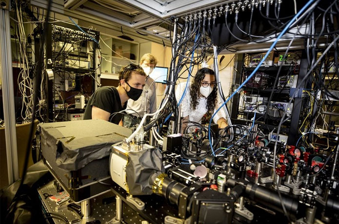 <p>Dolev Bluvstein (from left), Mikhail Lukin, and Sepehr Ebadi developed a special type of quantum computer known as a programmable quantum simulator. Ebadi is aligning the device that allows them to create the programmable optical tweezers.</p>

<p>Photos by Rose Lincoln/Harvard Staff Photographer</p>
