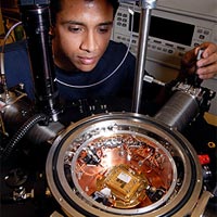 Georgia Tech Phd student Ram Krithivasan examines a silicon germanium chip inside a cryogenic test station at the Georgia Electronic Design Center at Georgia Tech in Atlanta. IBM and Georgia Tech have announced that they have broken the world silicon speed record with a chip that operates at half a trillion cycles per second, some 250 times faster than chips found in conventional cell phones.<br /><br />Georgia Tech Photo: Gary Meek