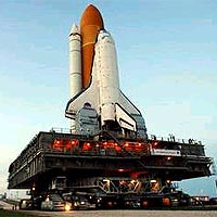 In the waning twilight, the service structures on Launch Pad 39B and the Mobile Launcher Platform carrying Space Shuttle Discovery glow with lights at NASA's Kennedy Space Center. Credit: NASA/KSC