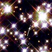 Three unlikely companions - two burned-out stars and a planet - orbit each other near the crowded core of an ancient globular cluster of more than 100,000 stars. Only one companion, however, is visible in the image. In this image, taken by NASA's Hubble Space Telescope, the white arrow points to a burned-out white dwarf star. Radio astronomers discovered the white dwarf and the other burned-out star - a rapidly spinning neutron star, called a pulsar - a decade ago. The third companion's identity was a mystery. Was it a planet or a brown dwarf? The object was too small and too dim to image.
<P>
Hubble observations of the dim white dwarf helped astronomers to precisely measure the mass of the mystery object (2.5 times larger than the mass of Jupiter), confirming that it is a planet. In fact, it is the farthest and oldest known planet. Hubble's Wide Field and Planetary Camera 2 resolved individual stars near M4's densely packed core [right] and pinpointed the white dwarf.
<P>
The Hubble observations of the white dwarf held the key to discovering the identity of the third companion. Astronomers used Hubble to measure the white dwarf's color and temperature. By knowing those physical properties, astronomers then calculated the white dwarf's age and mass. They then compared that information to the amount of wobble in the pulsar signal, which allowed astronomers to calculate the tilt of the white dwarf's orbit as seen from Earth. That critical piece of evidence, when combined with the radio studies of the wobbling pulsar, allowed astronomers to determine the tilt of the planet's orbit and subsequently its mass.
<P>
The cluster is located 7,200 light-years away in the summer constellation Scorpius. The Hubble image was taken in April 1996.
<P>
Credit for Hubble photo: NASA and H. Richer (University of British Columbia)