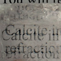 <p>
	This image shows a calcite crystal laid upon a paper, causing all the letters to show double refraction.</p>
