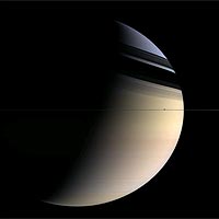 Shadows of rings fall on Saturn. The moon Enceladus is visible right of center in the ringplane. <br/>
<br/>
Image credit: NASA/JPL/Space Science Institute