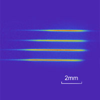 <p>
	The fluorescence from the four atomic ensembles. These ensembles are the four quantum memories that store an entangled quantum state.</p>
<p>
	[Credit: Nature/Caltech/Akihisa Goban]</p>
