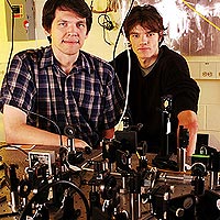 Researchers Thierry Chaneliere and Dzmitry Matsukevich pose with equipment used to demonstrate storage of a single photon in a quantum memory.<br/>
Georgia Tech Photo: Gary Meek