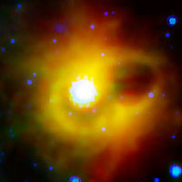 This image shows a ghostly ring extending seven light-years across around the corpse of a massive star. The collapsed star, called a magnetar, is located at the exact center of this image. NASA's Spitzer Space Telescope imaged the mysterious ring around magnetar SGR 1900+14 in infrared light. The magnetar itself is not visible in this image, as it has not been detected at infrared wavelengths (it has been seen in X-ray light). (Photo: NASA/JPL-Caltech)