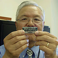 Dr. John Kim with the new ultra-miniature Rubidium atomic clock.
The ultra-miniature Rubidium atomic clock is the next-generation, super-accurate clock no bigger than a matchbox and loses only one second every 10,000 years.
<P>
Image Courtesy: Office of Naval Research. 
