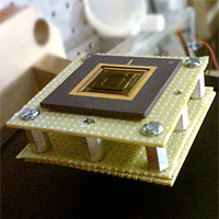 <p>
	A new energy harvesting device converts low-frequency vibrations into electricity. The device, the size of a U.S. quarter, is shown mounted on a stand.<br />
	Photo: Arman Hajati</p>
