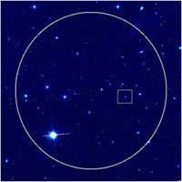 Hubble Space Telescope image of the sky surrounding the afterglow and host galaxy of the HETE short burst of July 9, 2005. The circle indicates the region of sky that HETE saw the burst from; according to the HETE team we would find the burst within this region. The box, inset, indicates where the X-ray and optical afterglow of the burst was ultimately found. The colors indicate the intensity of red light (814 nm) as seen by the Advanced Camera for Surveys instrument on HST. <br/>
<br/>
Credit: Derek Fox/Penn State University