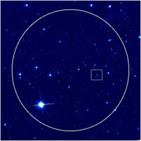 Hubble Space Telescope image of the sky surrounding the afterglow and host galaxy of the HETE short burst of July 9, 2005. The circle indicates the region of sky that HETE saw the burst from; according to the HETE team we would find the burst within this region. The box, inset, indicates where the X-ray and optical afterglow of the burst was ultimately found. The colors indicate the intensity of red light (814 nm) as seen by the Advanced Camera for Surveys instrument on HST. <br/>
<br/>
Credit: Derek Fox/Penn State University