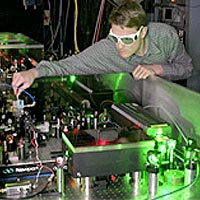 NIST physicist Scott Diddams adjusts a femtosecond laser system that is an important component of next-generation atomic clocks based on optical rather than microwave frequencies.
<P>
©2004 Bruce Erik Steffine
