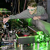 NIST physicist Scott Diddams adjusts a femtosecond laser system that is an important component of next-generation atomic clocks based on optical rather than microwave frequencies.
<P>
©2004 Bruce Erik Steffine
