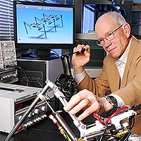 Professor Wayne Book and colleagues at four other universities are designing the Compact Rescue Crawler robot. Book's lab is contributing its expertise on haptics -- the 'feel' associated with operating a mechanical device.<br /><br />Georgia Tech Photo: Gary Meek