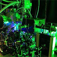 JILA's scanning photoionization microscope (SPIM) includes an optical microscope (in vacuum chamber, background) and an ultrafast laser (appears as blue, foreground). <br /><br />Credit: O.L.A. Monti, T.A. Baker, and D.J. Nesbitt/JILA