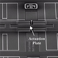 Scanning electron microscope image of the inchworm actuator. The inchworm design has a tangential force actuation plate in its central section, and on its two ends are frictional clamps where normal force is applied. In the clamps, load is applied electrostatically but borne mechanically to develop friction forces. To obtain motion, the leading clamp is fixed in place with a large voltage. The plate is then actuated by attracting it towards the substrate. Because the actuation plate is now bending, the trailing clamp, which is not loaded, slides a short distance (~ 40 nanometers) towards the leading clamp. The trailing clamp is now held fixed with a large voltage, and the voltages on the leading clamp and plate are turned off. The leading clamp then slips forward. This cycle is repeated over and over to obtain large-scale motion with very high precision. 
<P>
Image copyright: Sandia