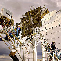 SANDIA RESEARCHER Chuck Andraka makes adjustments to a Stirling Energy Systems, Inc. solar dish-engine system installed at Sandia's National Solar Test Facility earlier this year. Five more will be erected by January as test units. (Photo by Randy Montoya) 
