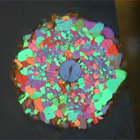 The image is a cross section of a 5 percent carbon-doped wire taken with polarized light. The picture shows all of the small, ~10-micron-sized grains lit up in wonderful colors. (Photo courtesy of the U.S. Dept. of Energy's Ames Laboratory)


