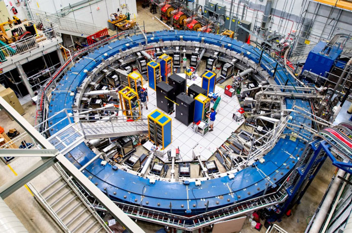<p>The muon g-2 ring sits in its detector hall amidst electronics racks, the muon beamline and other equipment at the U.S. Department of Energy’s Fermi National Accelerator Laboratory. This experiment studies the precession (or wobble) of muons as they travel through the magnetic field.</p>

<p>Courtesy: Fermi Lab</p>
