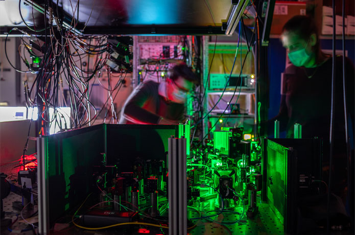 <p>Researchers work on one of the quantum network nodes, where mirrors and filters guide the laser beams to the diamond chip. Courtesy: TUDelft</p>
